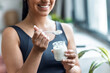 © nenetus - Sporty woman eating yogurt at home