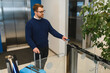 © Serhii - Man with luggage scanning keycard at turnstile