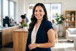 © Meow Creations - Professional Hispanic woman smiling with arm tattoo in office