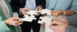 © fizkes - Close up diverse businesspeople hands holding puzzle pieces connecting them together collaborating on business project challenges in team unite forces for successful problem solving strategy planning