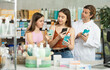 © JackF - Mother and daughter scans code on medicinal mouthwash to check expiration date. Male pharmacist helps to choose the best mouthwash
