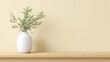 © Emilio - Minimalist white ceramic vase with green plant on wooden table against soft neutral background. Calm interior composition of mental recharge, balance, simplicity and peaceful lifestyle