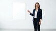 © Yahyah - A smiling businesswoman in a blue blazer pointing to a blank whiteboard in a modern office space