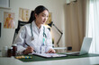 © matinee - Doctor reviewing medical records and treatment plan in bright examination room. Medical and healthcare assessment concept.