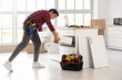 © Pixel-Shot - Male worker assembling counter with drawers in kitchen