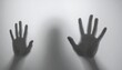 © Quirky - Human silhouette pressing against a translucent surface, hands visible