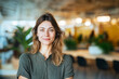 © boxstock production - Smiling female startup founder standing in bright modern open office