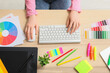 © Pixel-Shot - Female designer working with graphic tablet, stationery and color palettes at table in office, top view