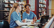 © peopleimages.com - Women, medical students and talk with laptop at library for research, smile and brainstorming at campus. Girl, healthcare scholarship and computer with insight, discussion and listen at university