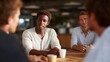 © forenna - Circle of veterans sits in community center discussing shared experiences, coffee cups on worn wooden table, supportive gestures and listening postures captured, perfect for peer counseling, PTSD