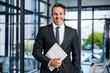 © peopleimages.com - Business, man and portrait with folder in office for case file, witness statement and legal document. Happy, mature attorney and report at law firm for trial preparation, court summons and integrity