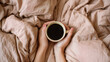 © Nuchylee - Cozy hands holding cup coffee morning bed linen warm beverage calm