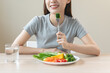 © Pormezz - Asian females eating salad as breakfast for good health