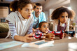 © Geber86 - Father watching children play video games at home