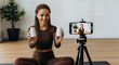© Lucianastudio - Fitness influencer shares health supplements on camera for online video content