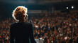© Mrammon - Woman speaker public speech business conference leadership talk large audience motivation seminar stage corporate event professional woman keynote address Confident woman speaker delivering public