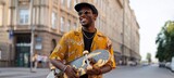 Man holding skateboard on city street.