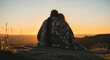 © Imaginarium_photos - Romantic Couple Embracing and Watching Golden Sunset on Mountain