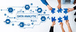 © InfiniteFlow - A vibrant scene showing a team working together to assemble puzzle pieces, symbolizing data analytics, machine learning, and collaborative problem-solving in a modern office. Amity
