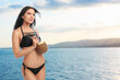 © New Africa - Pretty woman in swimsuit holding refreshing cocktail on beach near sea
