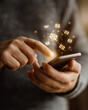 © Wasin Arsasoi - Digital Communication: A close-up view of a person using a mobile phone, with illuminated email symbols hovering, symbolizing modern communication and technology.