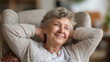 © Shahazadi - A happy elderly woman relaxing in a comfortable chair at home