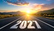 © Rat Art - Scenic highway with 2027 painted on the road leading into a sunset landscape, representing fresh start, future success, and new year journey.
