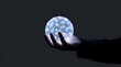 © Andry - Conceptual Image of a Hand Holding a Luminous Sphere Filled with Glowing Fiber Optic Dots and Network Lines Representing Global Connectivity and Data