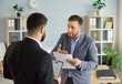 © Studio Romantic - Dissatisfied business people colleagues disputing having disagreement at workplace. Displeased coworkers arguing having conflict standing in office discussing contract. Business conflict concept.