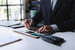 © crizzystudio - Business person analyzing financial data and market reports