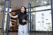 © crizzystudio - Young businesswoman entering coffee shop carrying tablet