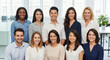 © MIAN - A diverse group of young professionals smiling together in a modern office setting.