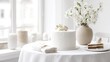 © Viktoriia - Elegant white cake with blossoms and minimalist decor on a sunlit table