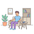 © El - A man sits on a couch in a living room with a bookshelf and plant.