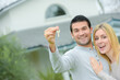 © auremar - Couple outside house holding keys