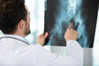 © auremar - male doctor points at pelvic x-ray