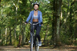 © auremar - fit woman is cycling in the forest