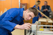 © auremar - industrial woodworking apprentice adjusting a machine