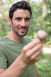© auremar - cheerful man found a mushroom in the forest