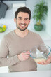 © auremar - closeup on man whisking eggs in bowl