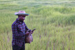 © arrowsmith2 - Modern African Farmer Using Digital Tablet in Green Rice Field