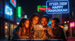 © shevtsovy - Smiling family gathers closely to light the candles on a menorah outdoors at night beneath a bright neon sign wishing happy Hanukkah.