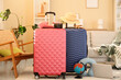 © Pixel-Shot - Suitcases with traveling accessories, laptop and photo camera in living room