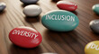 © PhotoArtHub - Close-up of colored stone with inscription lying on wooden surface, representing diversity, inclusion and equity concept, useful for social themes