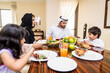 © oneinchpunch - Arab family wearing traditional emirati clothing bonding at home in Dubai