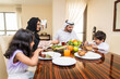 © oneinchpunch - Arab family wearing traditional emirati clothing bonding at home in Dubai