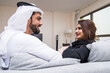 © oneinchpunch - Arab married couple wearing traditional emirati clothing at home - Middle eastern man and woman spending time together, domestic life in a traditional middle east family