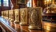 © Hendrastudio - A collection of antique brass playing card holders with ornate carvings displayed elegantly on a polished wooden surface in a luxurious indoor setting.