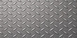 © MDNUR - A seamless industrial diamond plate texture features a hard metallic pattern on a gray steel surface, providing a rugged silver aluminum backdrop for construction and material design