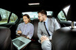 © BGStock72 - Korean woman and Caucasian man discuss ideas while seated in a car during a meeting